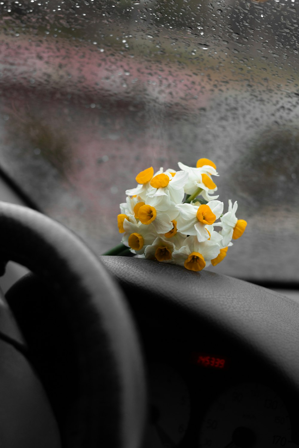 a bouquet of flowers sitting on the dashboard of a car