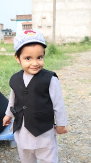 A cheerful Indian child wearing stylish blue jeans playing outdoors in Ahmedabad.