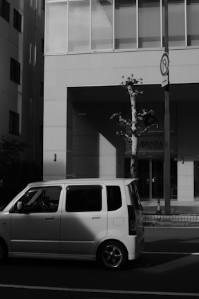 A compact car parked in a vibrant urban city street.