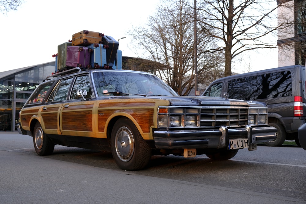 an old station wagon with luggage on top of it