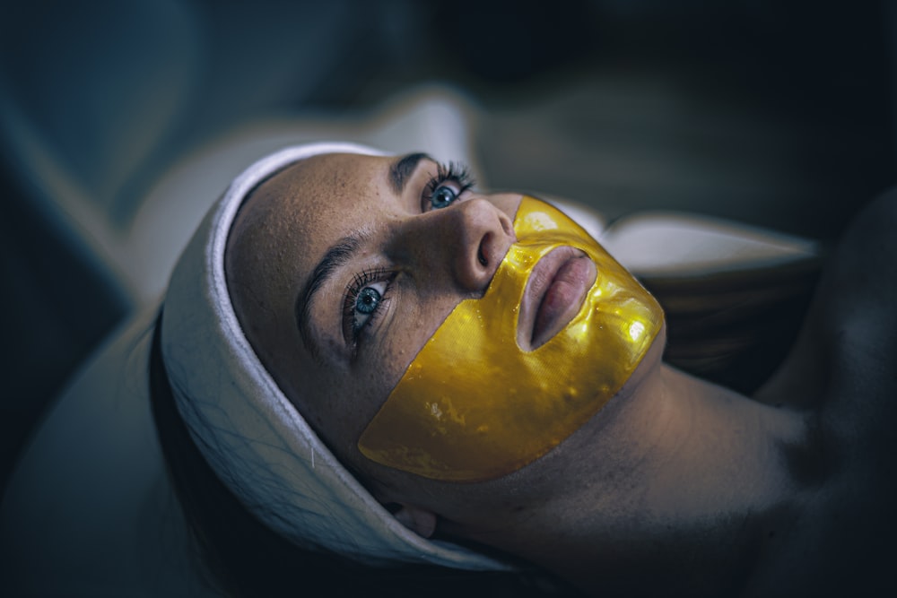 a woman with a yellow mask on her face