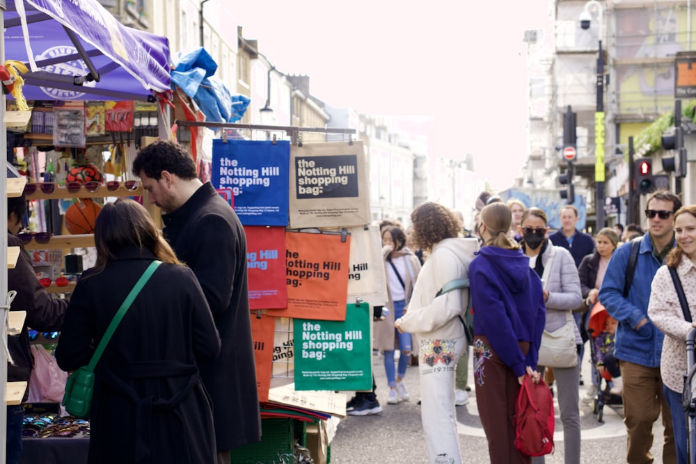 a crowd of people walking down a street