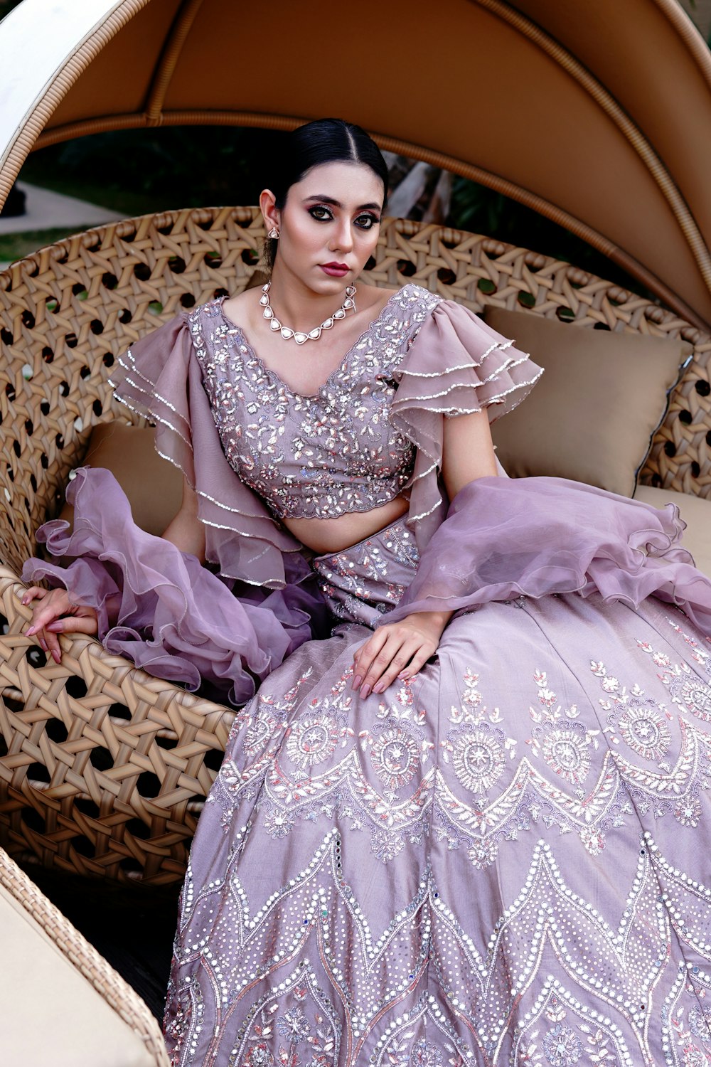 a woman in a purple dress sitting on a couch