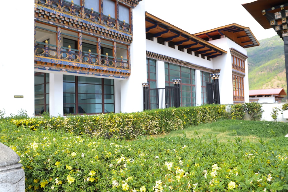 a building with a lot of windows and flowers in front of it