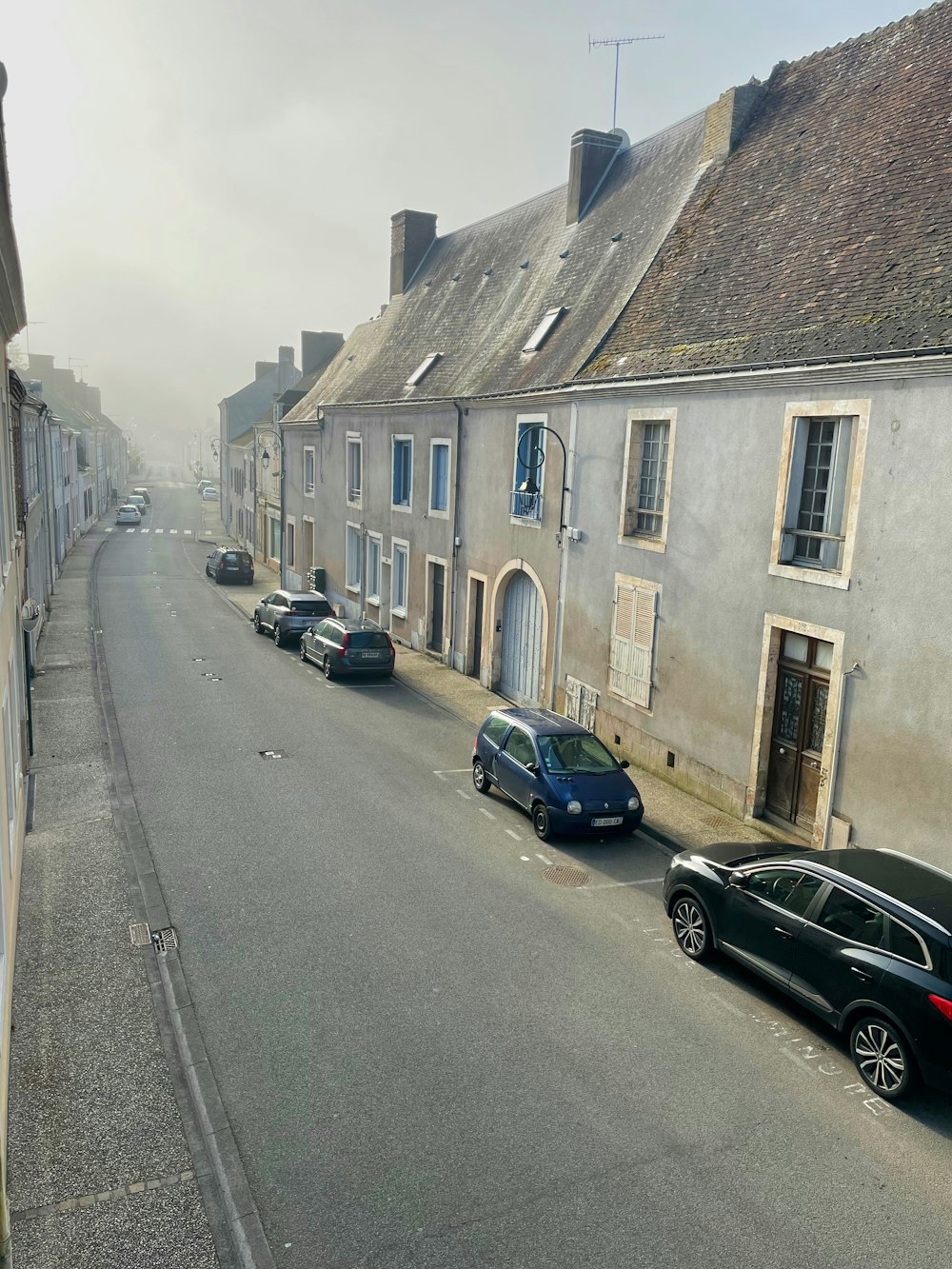 cars parked on the side of a street next to buildings