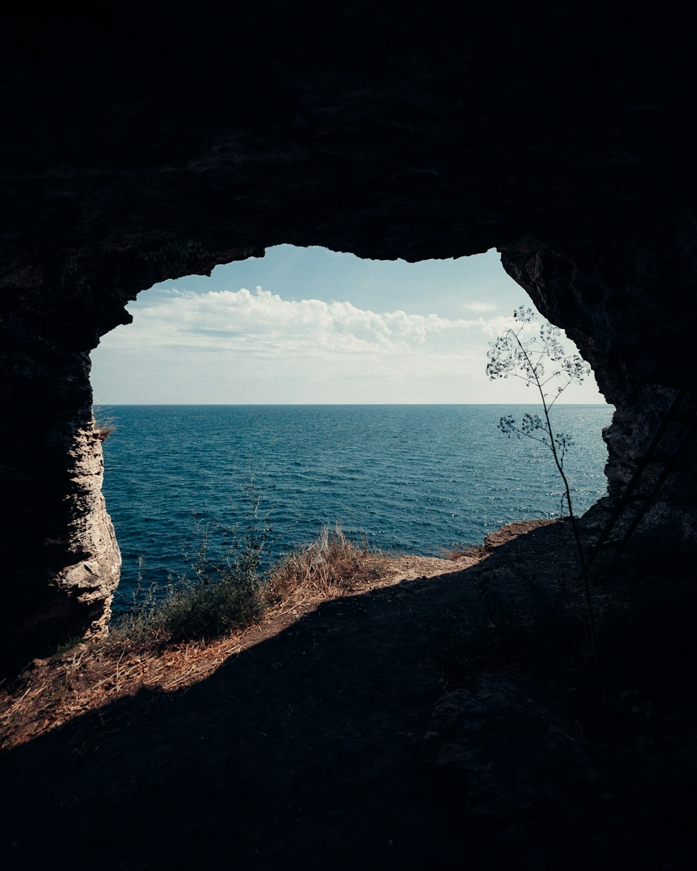 a view of a body of water from a cave