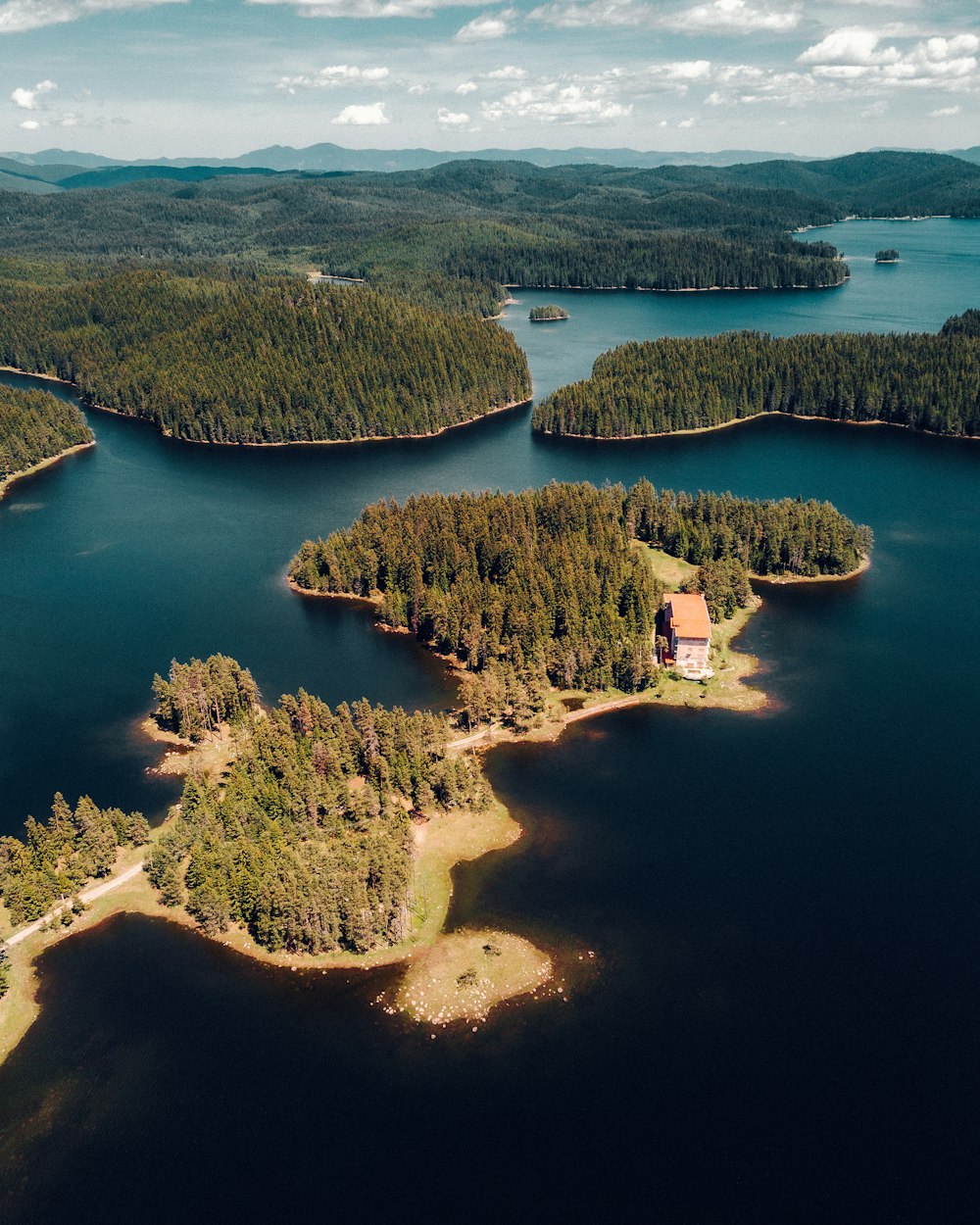 an aerial view of an island in the middle of a lake