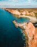 a large body of water next to a rocky shore