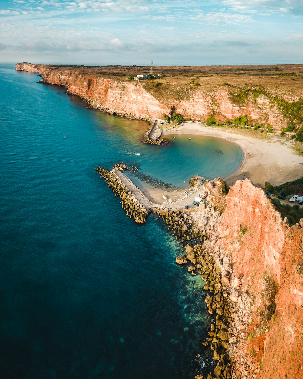 a large body of water next to a rocky shore