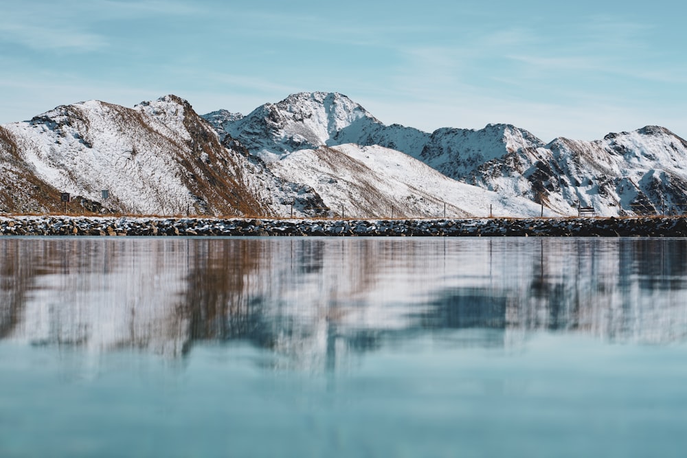 Eine Bergkette spiegelt sich im stillen Wasser eines Sees