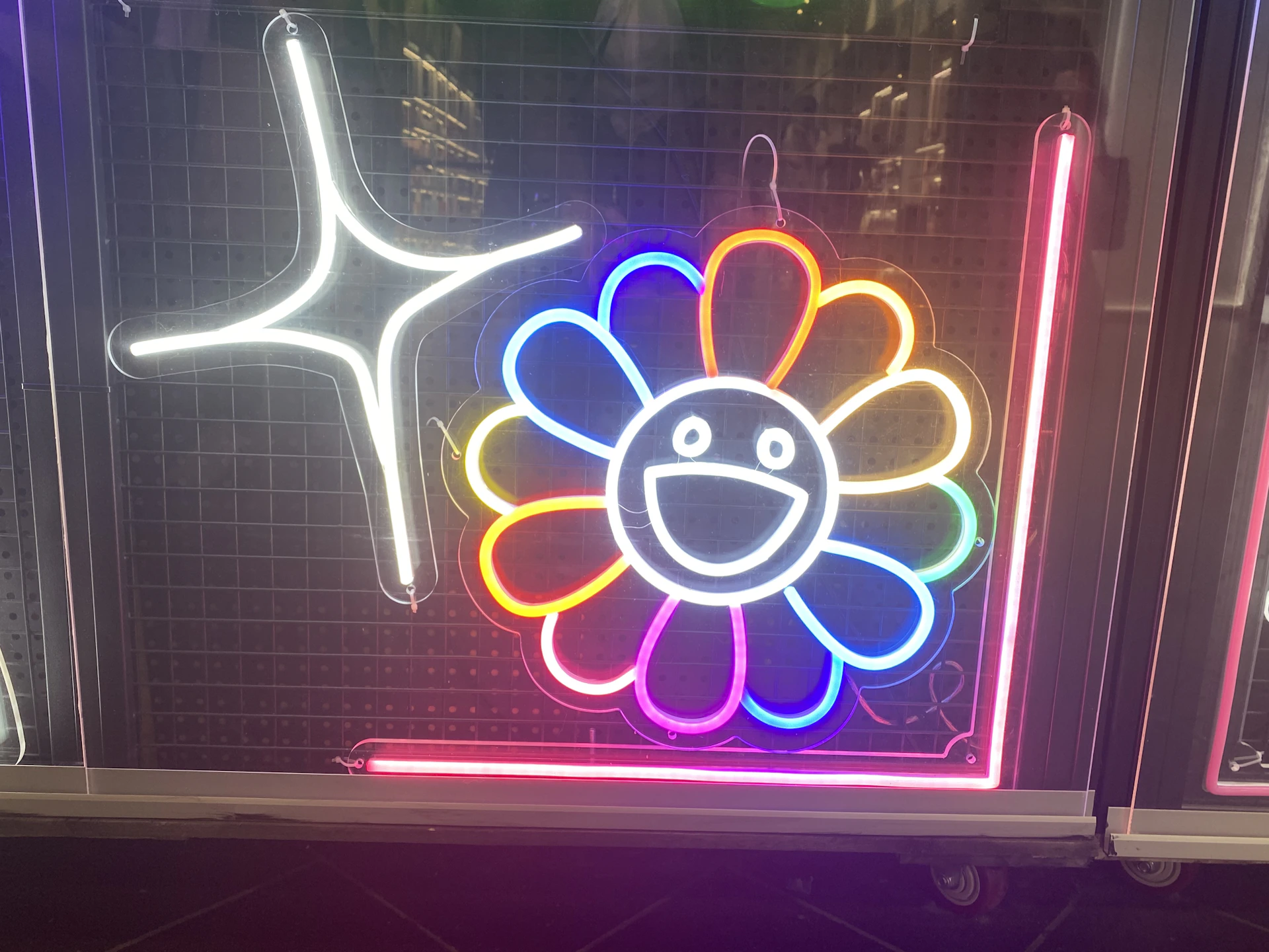 a neon sign with a flower on it