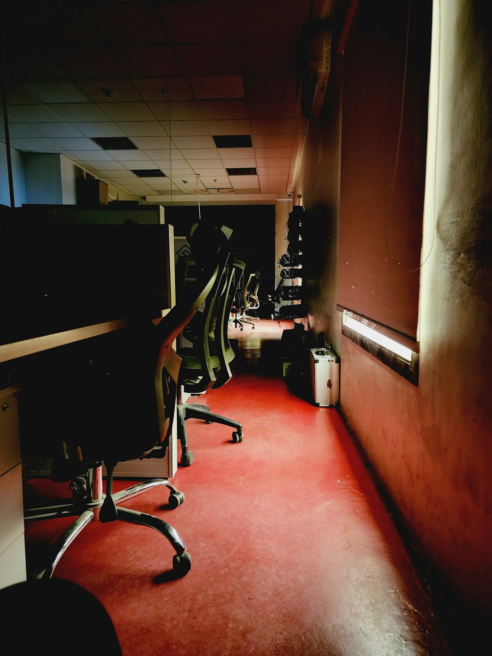 a room with a red carpet and a black chair