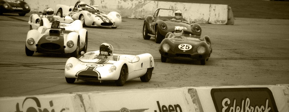 a group of race cars driving around a track