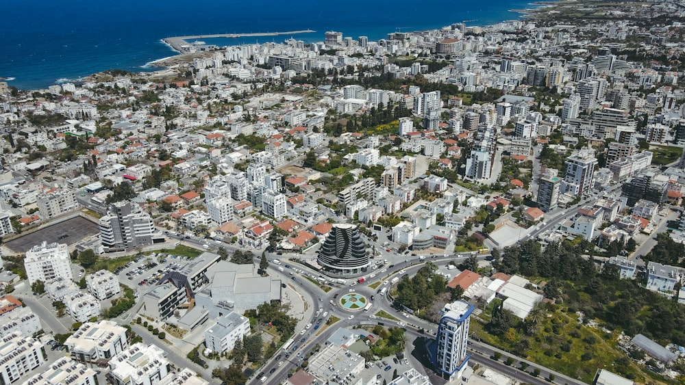 an aerial view of a city with a large body of water in the background