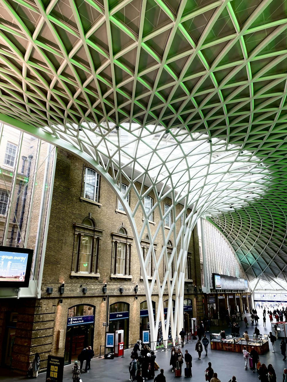 a group of people walking around a train station