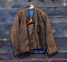 A cozy winter jacket draped over a rustic chair, showcasing a blend of style and comfort.
