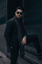 A stylish image of a young male model in a modern urban setting.