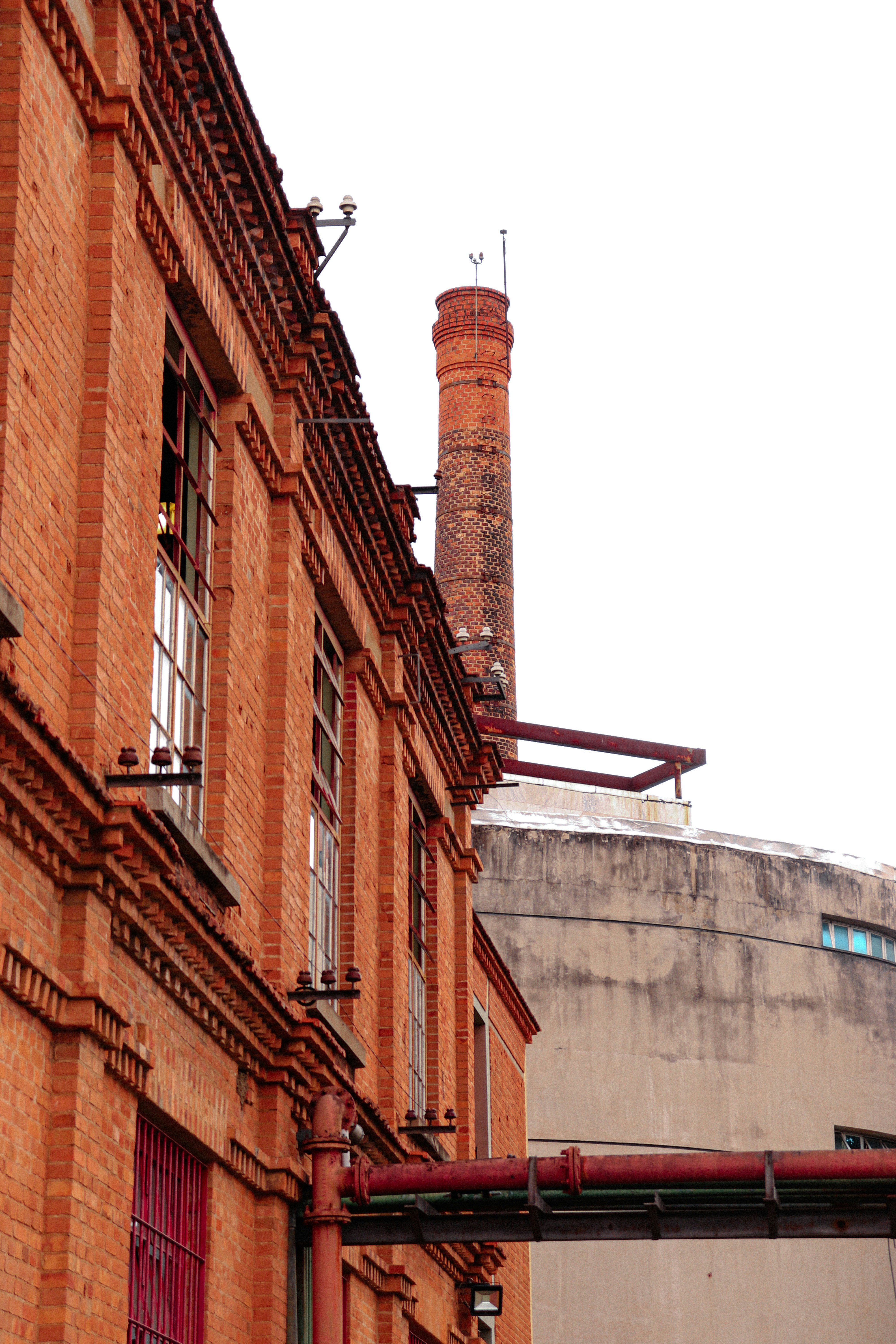 a tall brick building with a clock on it's side