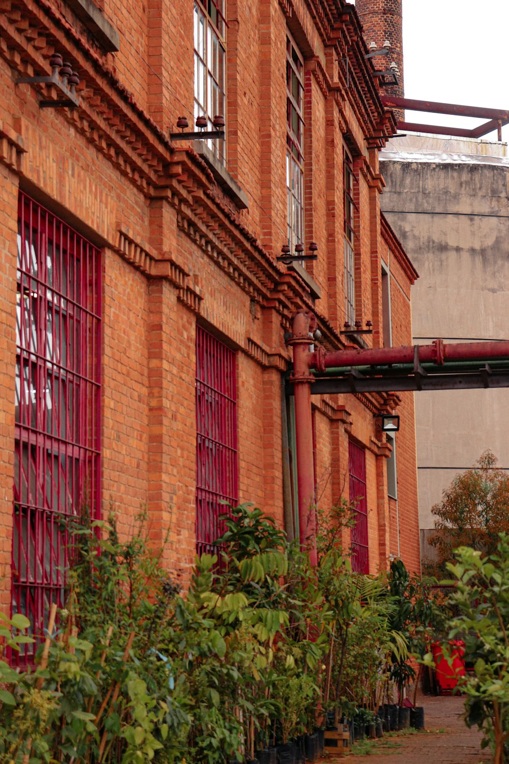 a red brick building with red shutters and windows