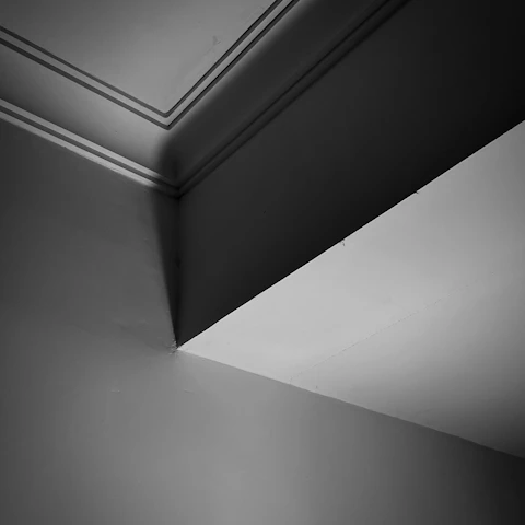 a black and white photo of a corner of a room