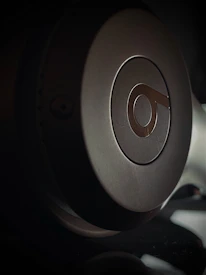 Close-up of a TC4 titanium alloy headphone shell being CNC machined with high precision.