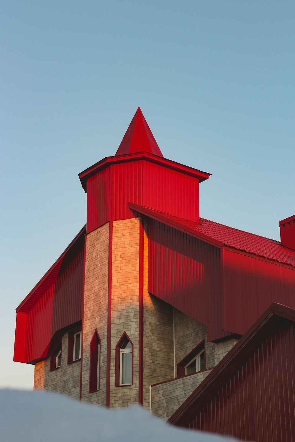 a large red building with a steeple on top of it