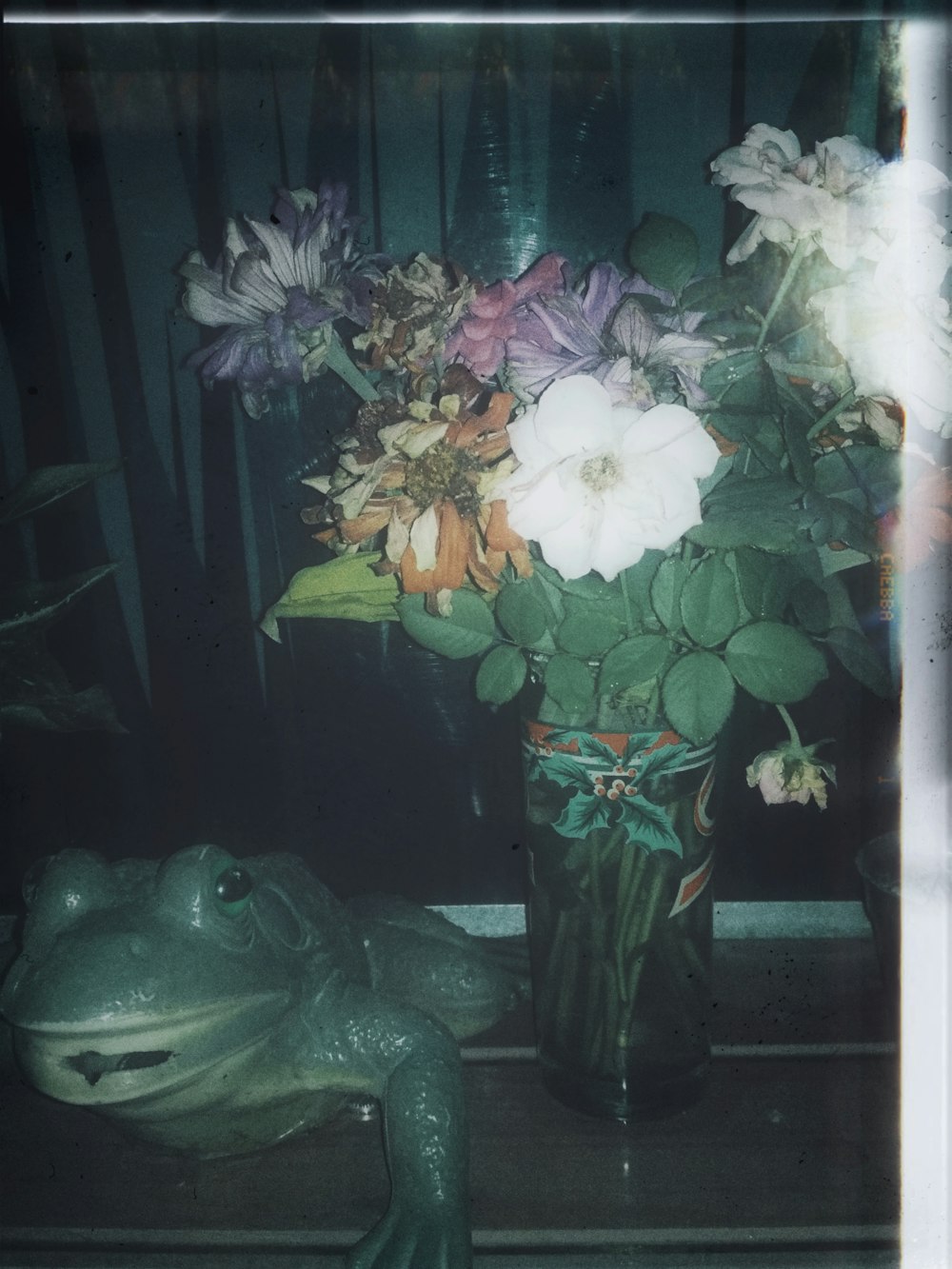 a vase of flowers sitting on a window sill