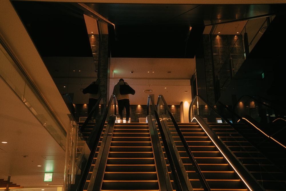 a man walking down a set of stairs at night