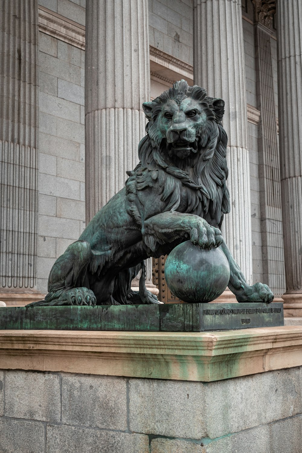 a statue of a lion sitting in front of a building