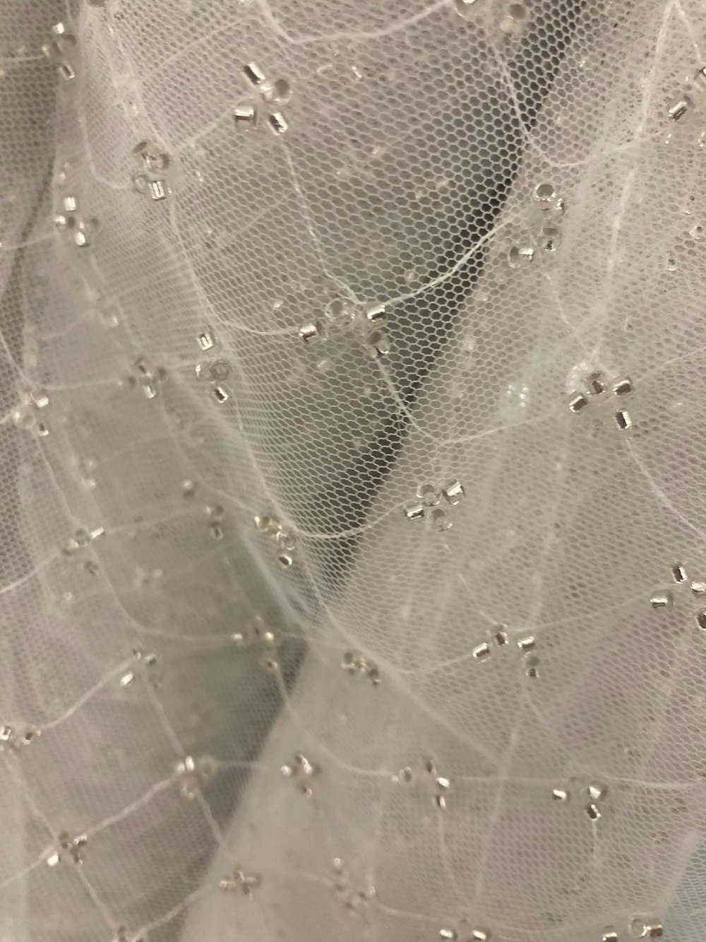 a close up of a veil with water droplets on it