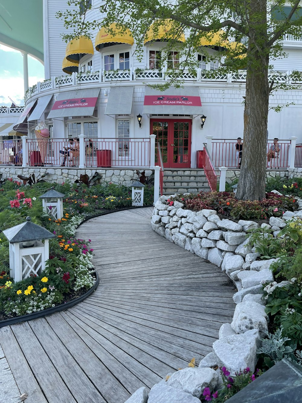 a wooden walkway leading to a white building