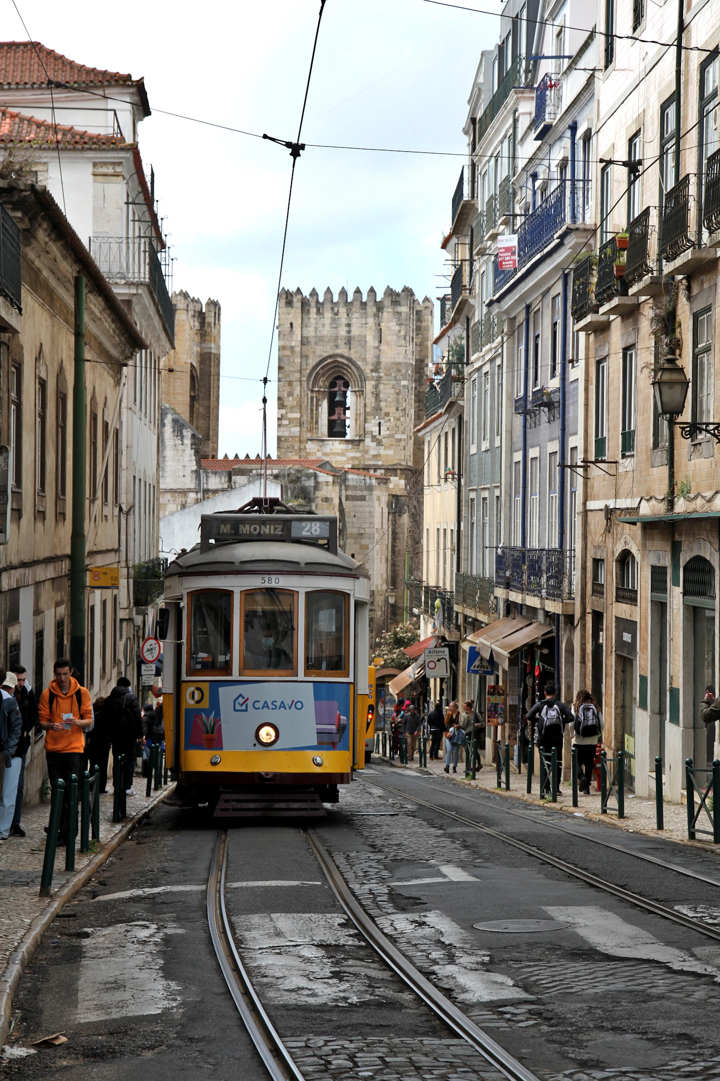 Tram 28 on a cobbled Lisbon street near the Sé cathedral and Alfama