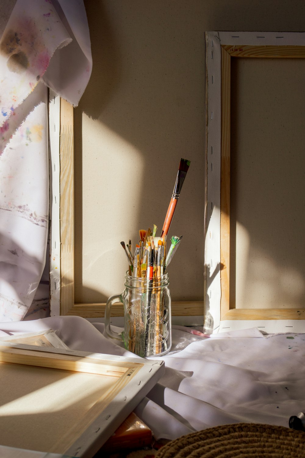 a jar of pencils sitting on top of a table