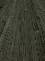 Detail of wood grain and clamps holding parts together during the furniture assembly process.