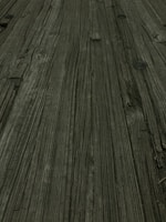 Close-up of a table surface showing the texture of repurposed wood and tire rubber.