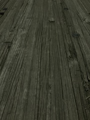 Close-up of wood grain and metal joints on a custom furniture piece.