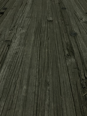 Close-up of a table surface showing the texture of repurposed wood and tire rubber.