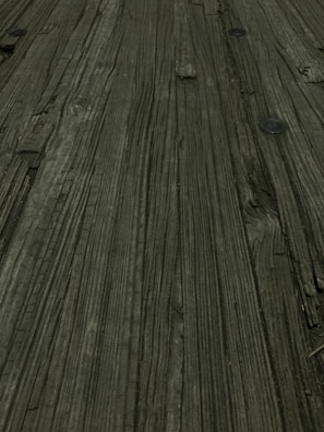 Detail of wood grain and clamps holding parts together during the furniture assembly process.