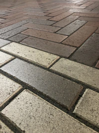 Close-up of a decorative stamped concrete walkway featuring a brick pattern.