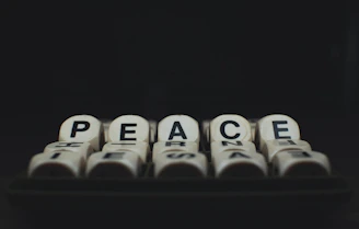 a group of dices with the words peace written on them