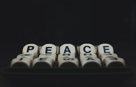 a group of dices with the words peace written on them
