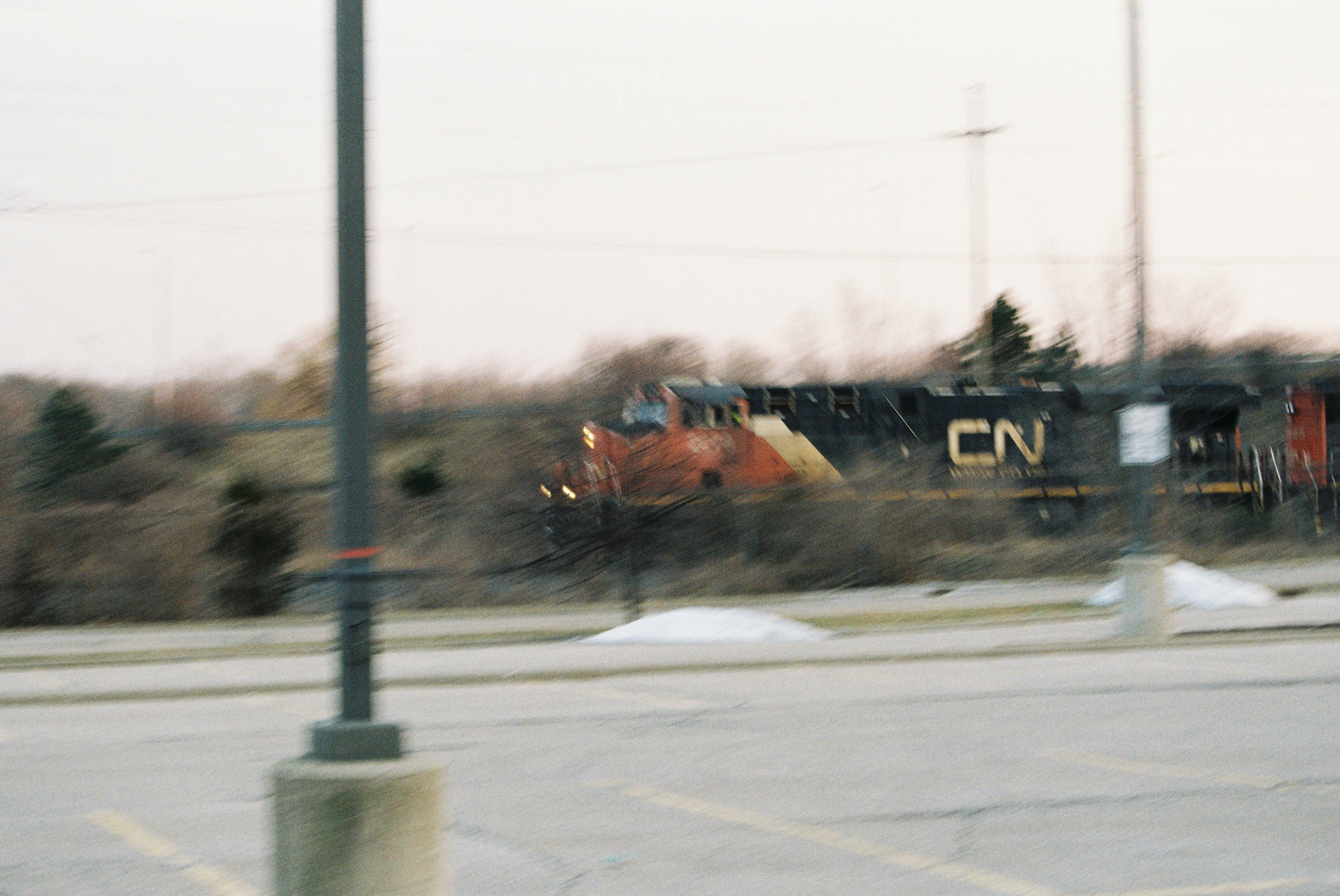 a train traveling down train tracks next to a forest
