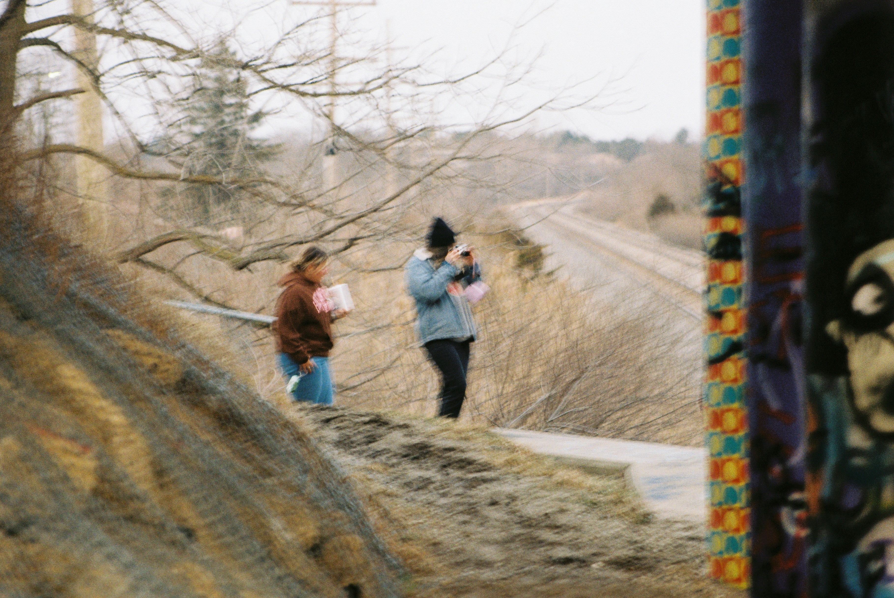 a couple of women standing on top of a hill