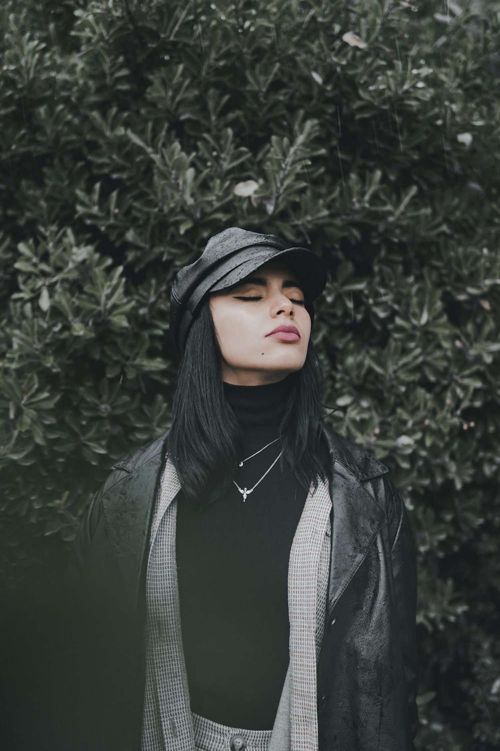 a woman wearing a black hat and a black jacket