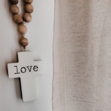 A peaceful room with soft lighting, cushions, and a cross on the wall.