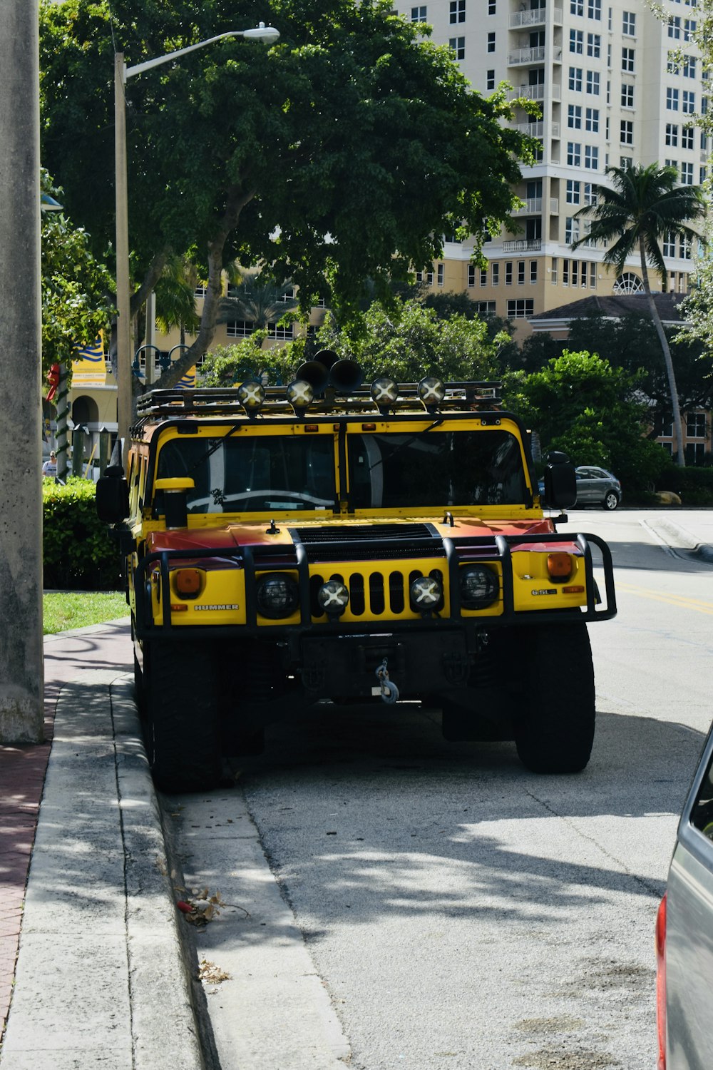 a yellow and red truck parked on the side of the road