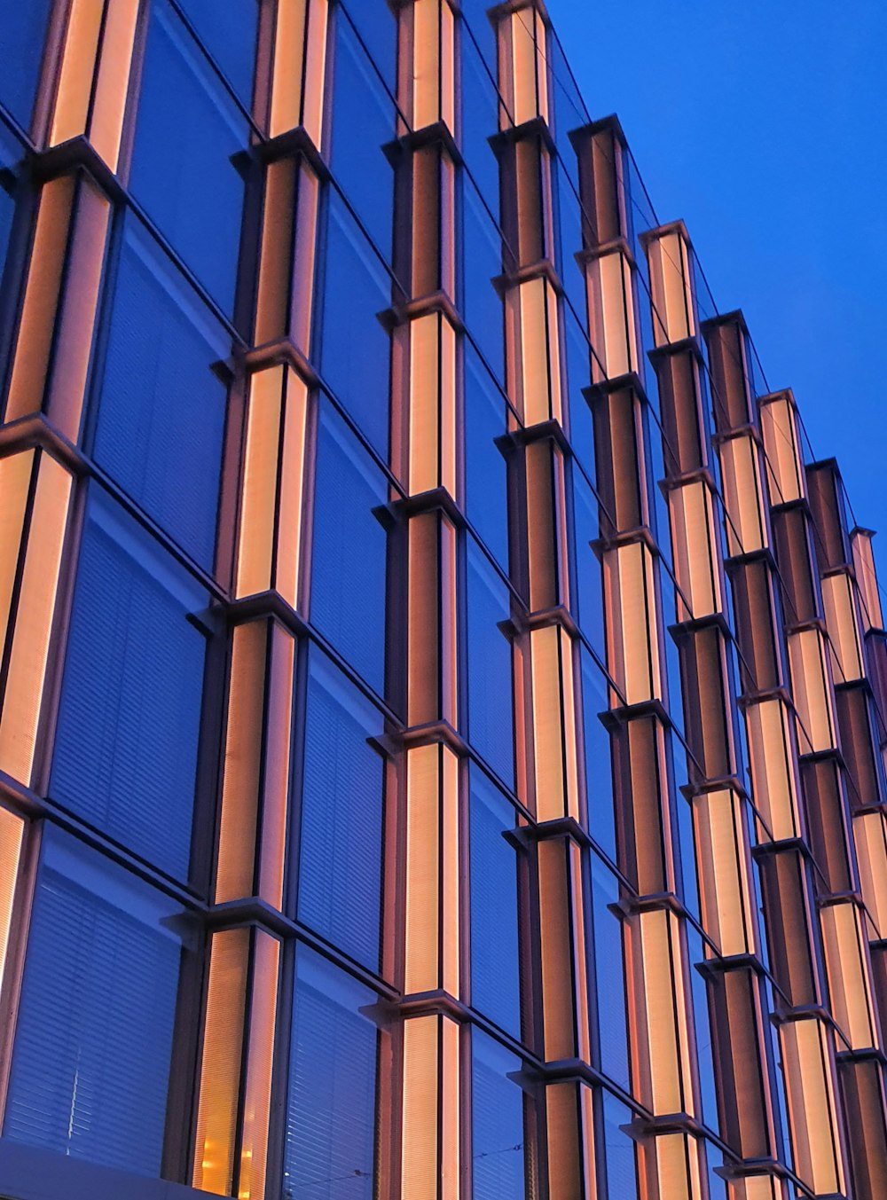 a tall building with lots of windows next to a street