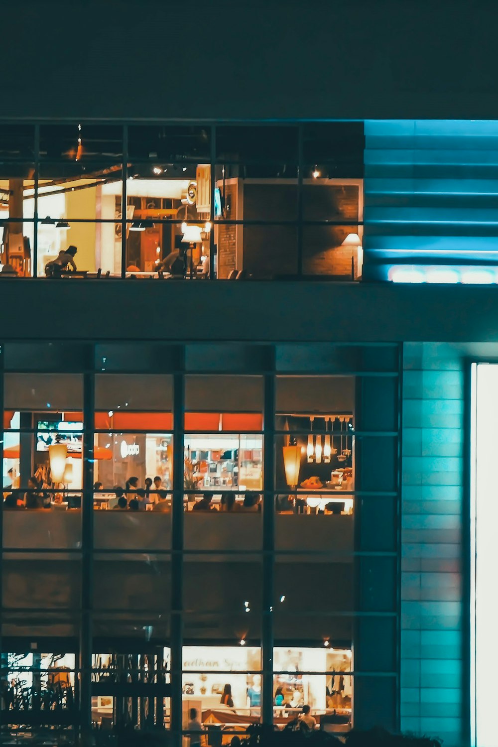 a view of a building at night from across the street