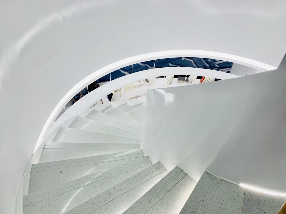 a spiral staircase in a building with a sky background