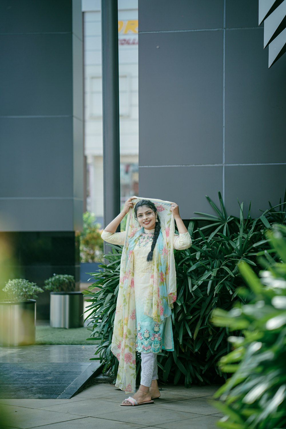 a woman standing in front of a plant